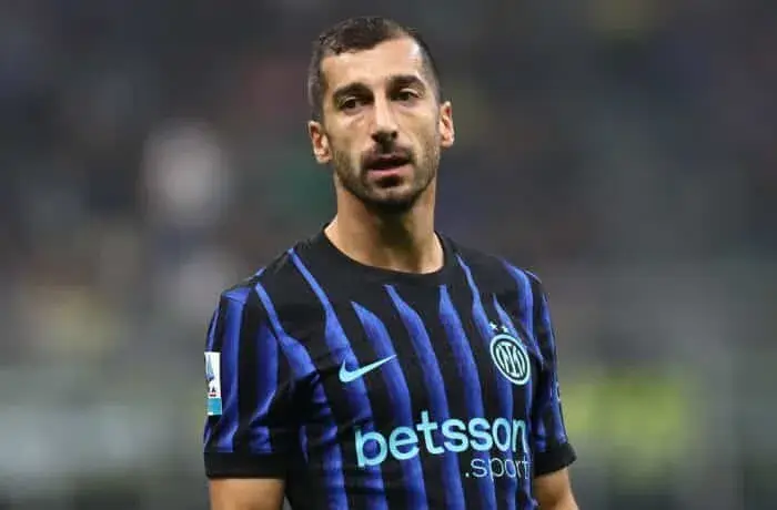 Soccer player in blue-and-black striped Inter Milan jersey looking forward on the field